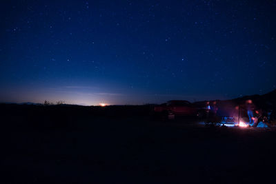 Silhouette landscape against sky at night