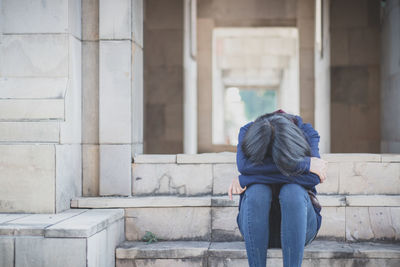 Sad woman sitting on steps