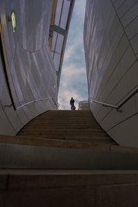 Low angle view of people on staircase against sky