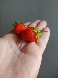 Close-up of hand holding strawberry