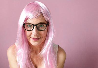 Lady with pink hair  smiling on pink background