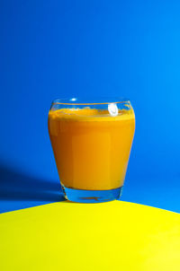 Close-up of drink against blue background