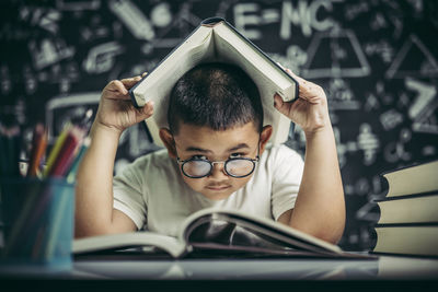 Portrait of boy sitting on table