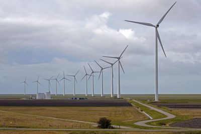 Windmill on field against sky