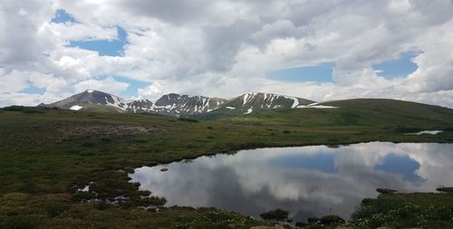 Scenic view of mountains against cloudy sky