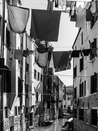 Clothes drying on street amidst buildings in city