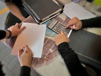 High angle view of people on paper at table