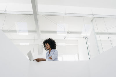 Young woman using laptop in office