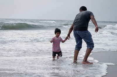 Full length of boys on beach