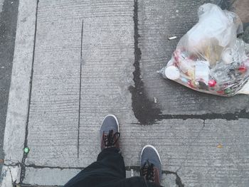 Low section of person standing on footpath