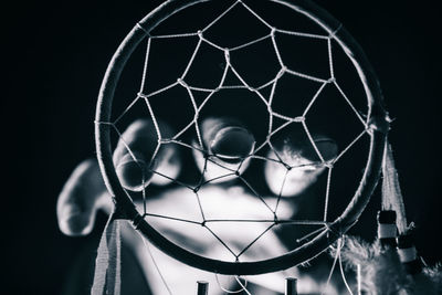 Low angle view of basketball hoop against black background