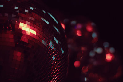 Disco balls in red party lighrs at night