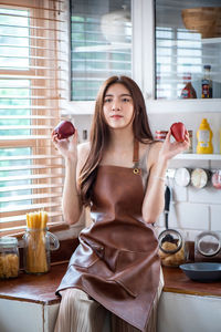 Portrait of a young woman drinking glass