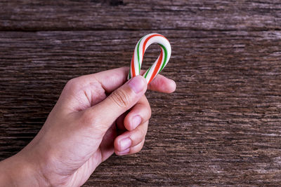 Close-up of hand holding red ring