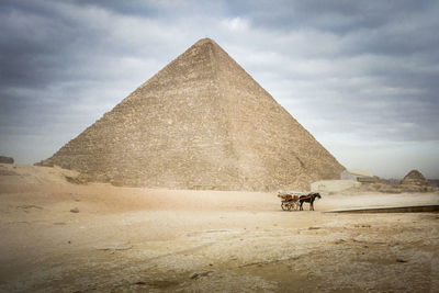 The great pyramid of khufu at giza with horse and carriage in the foreground