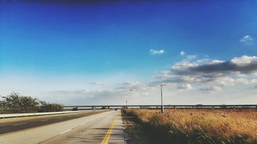 Scenic view of landscape against blue sky