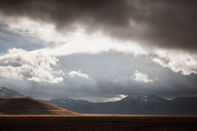 Scenic view of mountain against cloudy sky