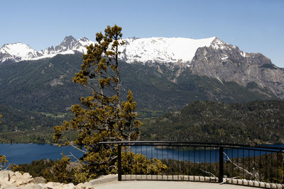 Scenic view of lake and mountains against clear sky