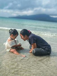 Rear view of girls on beach