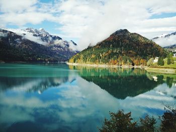Scenic view of lake against cloudy sky