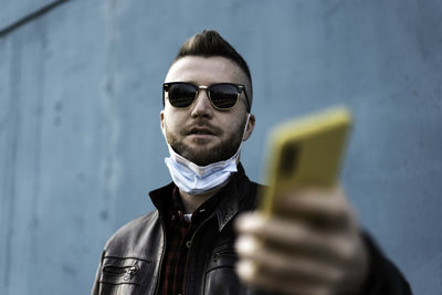 Portrait of young man using smart phone