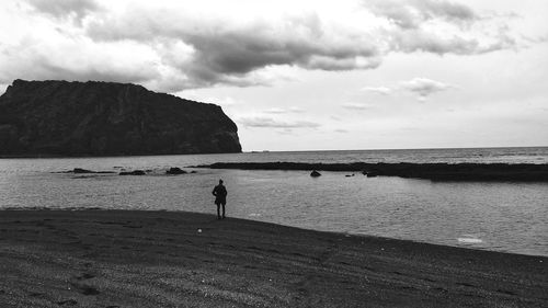 Man looking at sea against sky