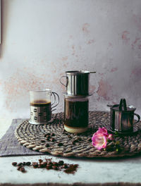 Close-up of black coffee in containers on place mat