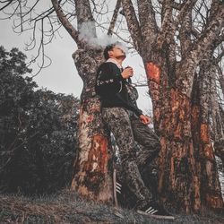 Full length of young man against trees in forest