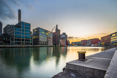 Bridge over river against buildings in city