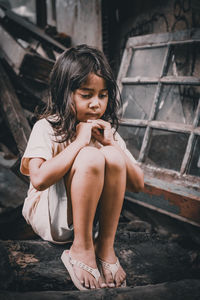 Portrait of young woman sitting on bench