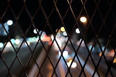 Full frame shot of chainlink fence at night