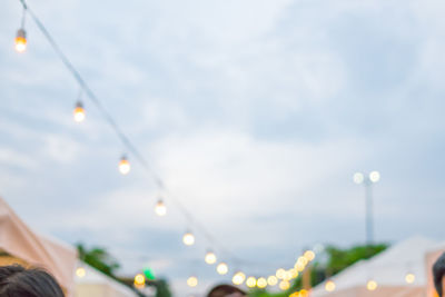 Low angle view of illuminated lights against sky