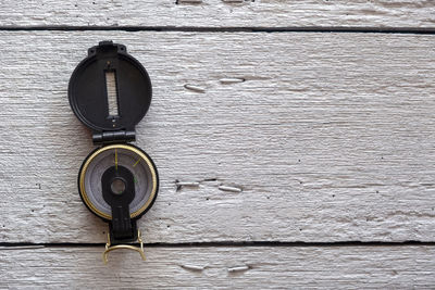 Close-up of metal on table against wall