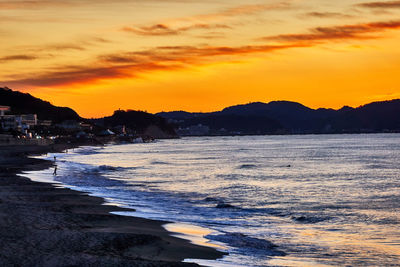 Scenic view of beach against sky during sunset