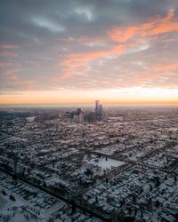 Aerial view of cityscape against sky during sunset