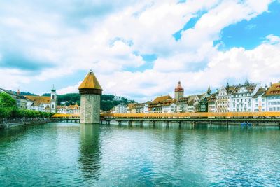 View of bridge over river against cloudy sky