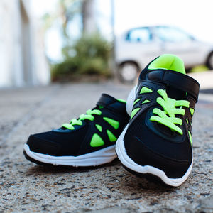 Close-up of black sports shoes on footpath