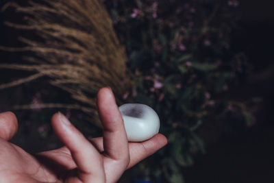 Close-up of hand holding soap sud