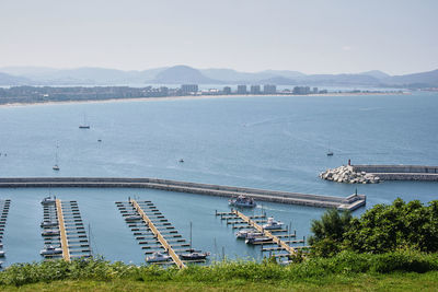 High angle view of sailboats in sea against sky