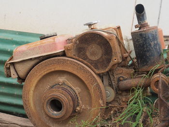 Close-up of abandoned tractor on field against sky