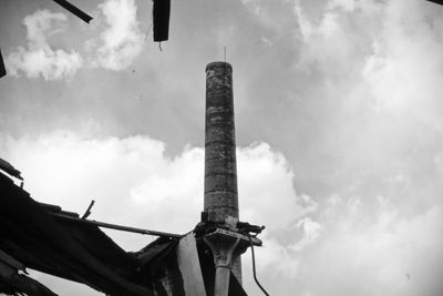 Low angle view of smoke stack against sky