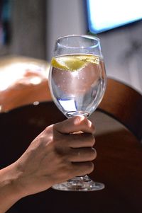 Close-up of hand holding drink on table