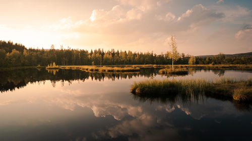 Scenic view of lake against sky during sunset