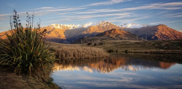 Scenic shot of calm lake against mountain range