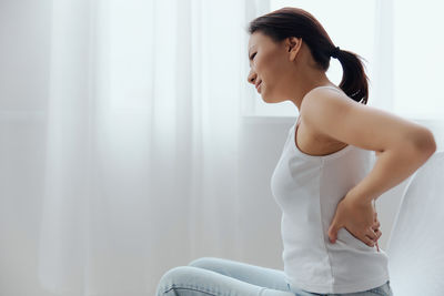 Young woman exercising at home