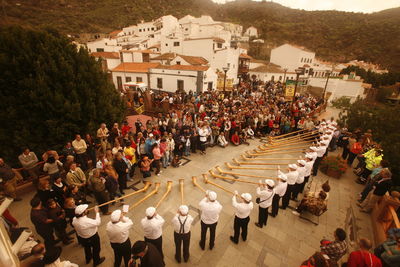 High angle view of men playing alphorn while performing at street