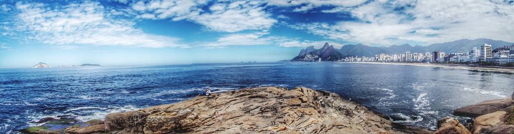 Scenic view of sea against cloudy sky