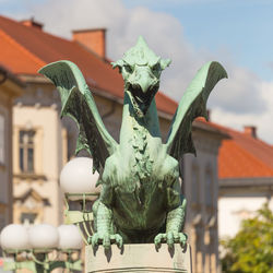 Low angle view of angel statue against building