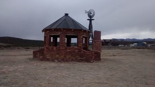 Abandoned building against cloudy sky