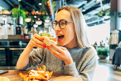 Portrait of young woman having food